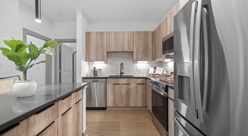 a kitchen with wood cabinets