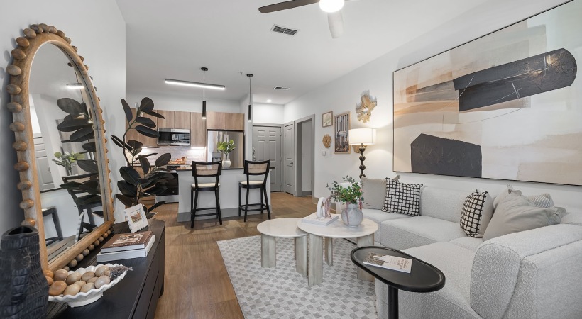 a living room with a couch, tables and chairs