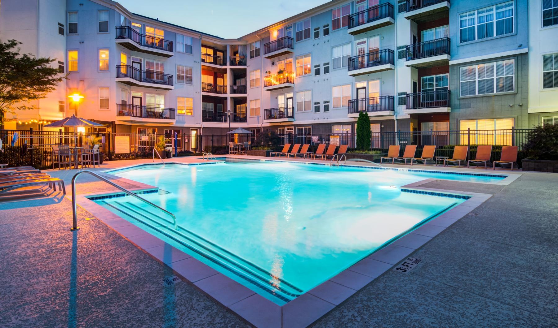 a swimming pool lit at night