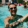 man in pool with tatoots